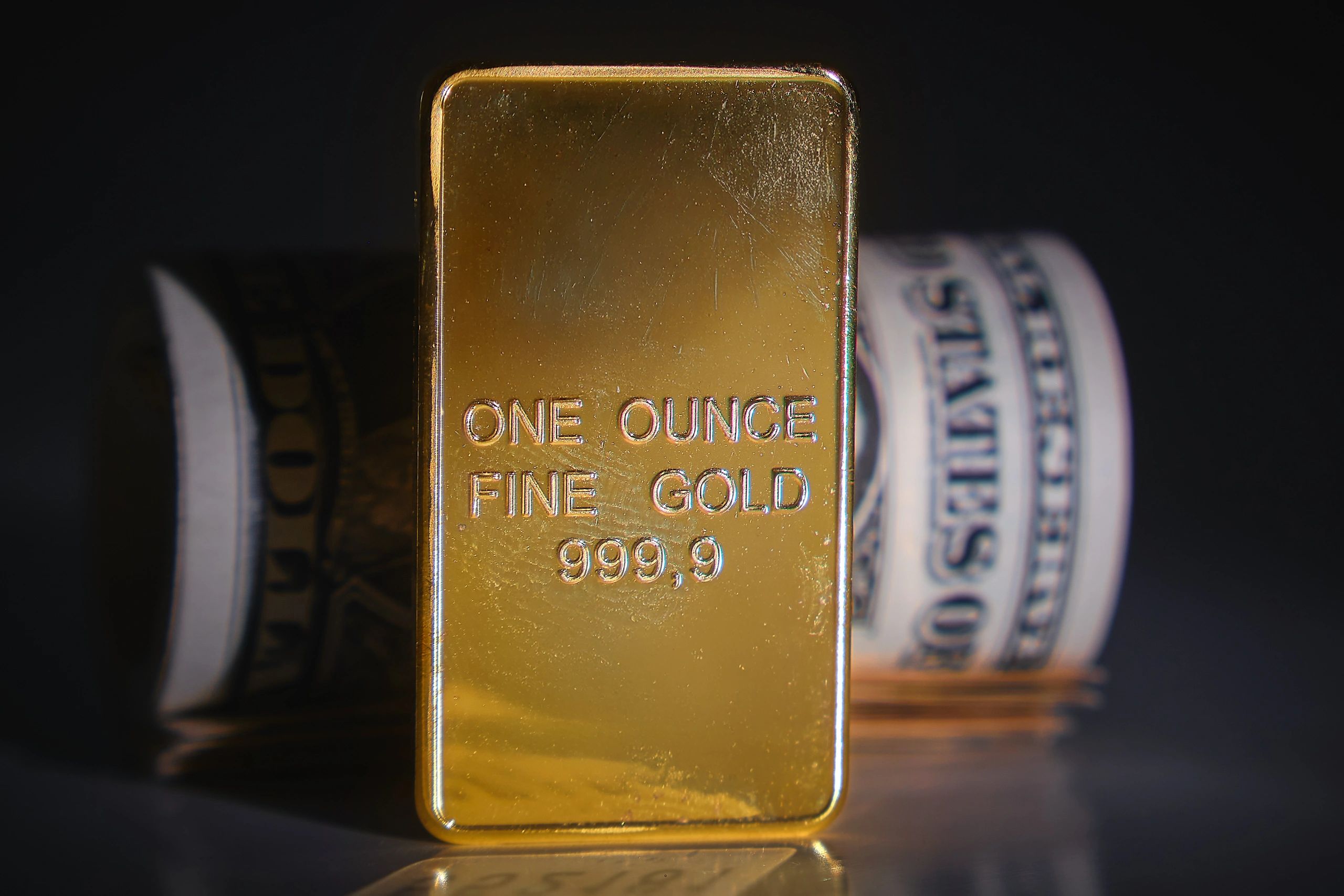 Gold bar and currency representing export supply